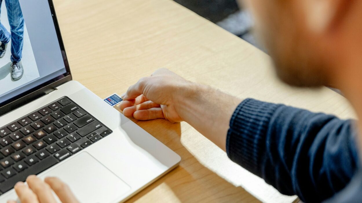 A man sitting in front of a laptop computer
